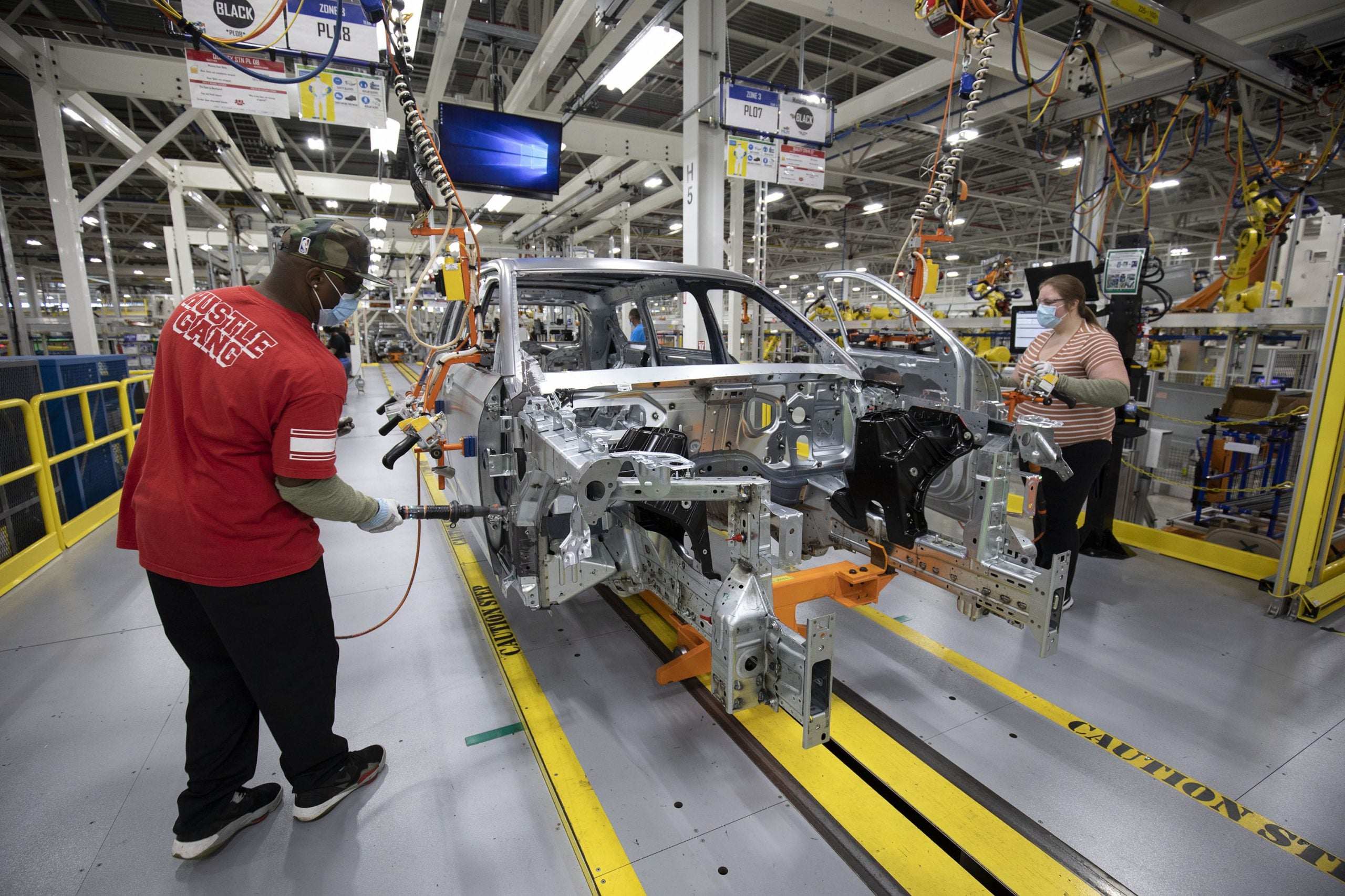 Two Stellantis workers assemble a Jeep Grand Cherokee at the Detroit Assembly Complex