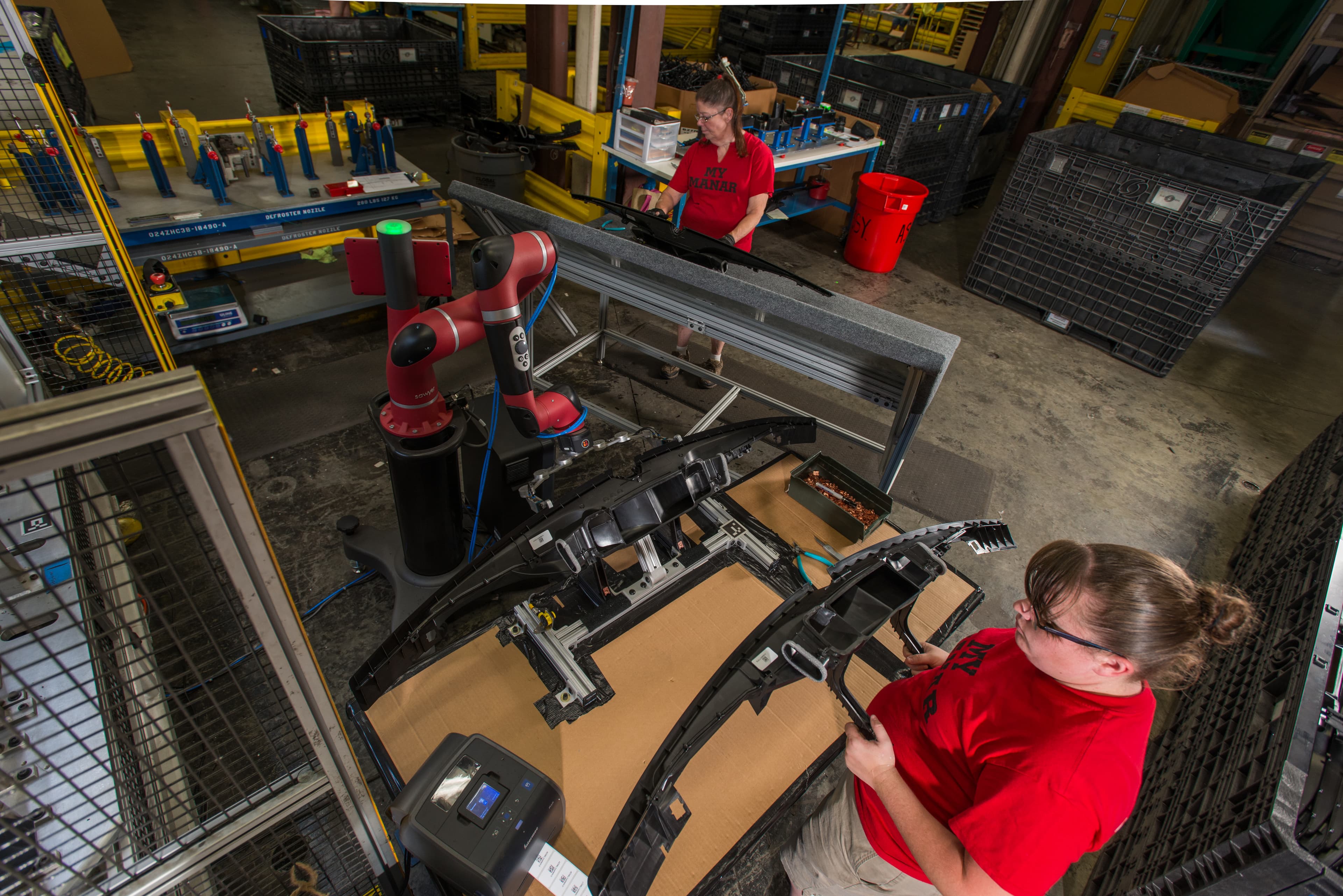 A manufacturing worker beside a collaborative robot at Tennplasco in Lafayette, Tennessee